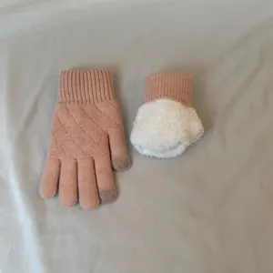 Pink winter knit gloves with cozy fleece lining and diamond pattern. Warm details.