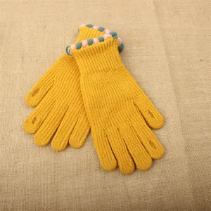 Knit touchscreen gloves detail shot, yellow winter warm gloves with cute pom pom cuffs.