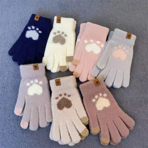 Detail close-up of cute cat paw knitted touchscreen gloves designed for warm winter wear.