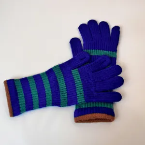 Detailed view of women winter long knitted gloves with blue green stripes and touch screen tips.