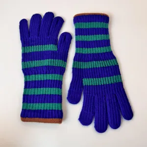 Close-up of winter knitted gloves detail, colorful striped pattern design, cozy cuff texture.
