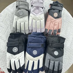 Detail view of winter ski gloves with waterproof fabric, plush lining and strap.