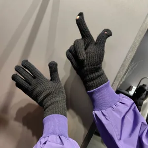 Knit touchscreen gloves detail showing open fingers design for winter cycling and outdoor warmth.
