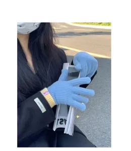 Close-up of women's blue knit gloves with ribbed cuffs, winter warm split-finger detail.