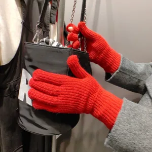Detailed view of winter warm red knitted gloves, soft split-finger thermal design for cold weather.
