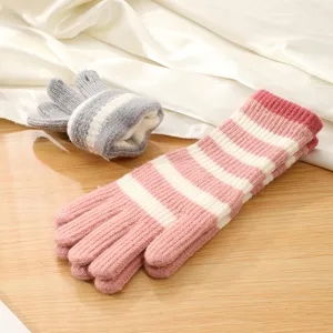 Detailed view of women's knitted striped long gloves and winter warm fingerless hand sleeves.