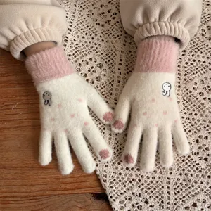 Close-up detail of cute rabbit embroidered warm winter knitted gloves, cozy plush pink cuffs.