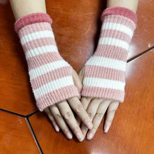 Knitted fingerless gloves in pink and white stripes, cozy winter arm warmers for women.