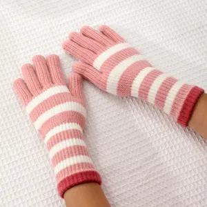 Detailed shot of pink and white striped knitted long gloves, perfect for winter warmth and style.