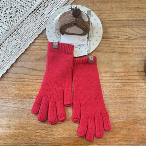 Red knitted winter gloves for women, stylish cute bear patch design warm cozy mittens.