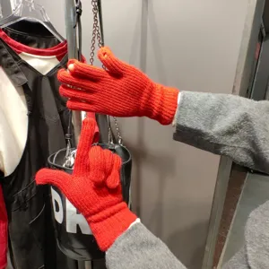 Red knitted touchscreen gloves for winter cycling, warm and practical two-finger design.