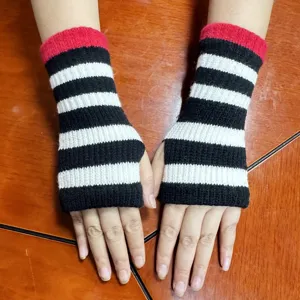 Black and white striped knit fingerless gloves with a red top cuff for autumn and winter.