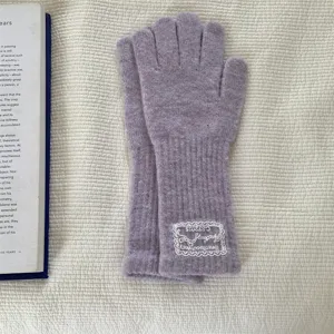 Detailed view of women's autumn winter long knit gloves in lavender with a delicate lace label.