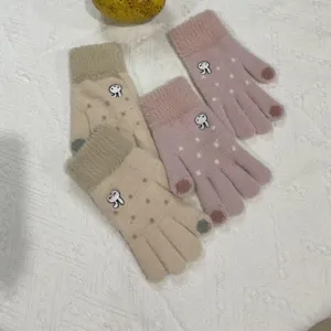 Close-up detail of cute rabbit embroidery plush knit touch screen winter warm gloves for women.