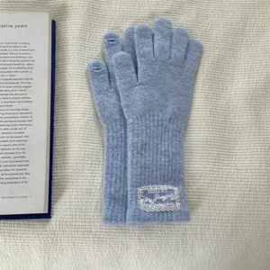 Long wool blend fingerless gloves in light blue with delicate lace label detail for women.
