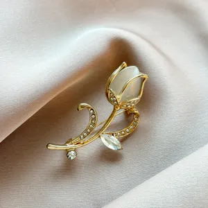 Exquisite tulip brooch detail view, gold-tone metal with sparkling rhinestones and stone.