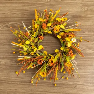 Full view of autumn harvest wreath decorated with sunflowers and orange leaves on wood