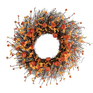 Detailed macro view of an autumn harvest wreath with mini pumpkins and vibrant berries