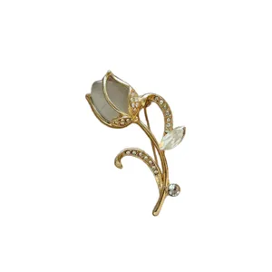 Elegant gold-tone tulip flower brooch decorated with sparkling rhinestones and cat eye stone.