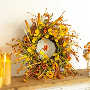 Detailed macro view of an autumn harvest wreath featuring sunflowers and yellow leaves