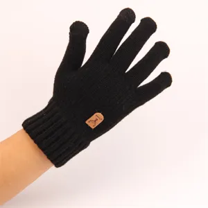 Detail view of black knit touchscreen gloves, warm cashmere-feel fabric for winter.