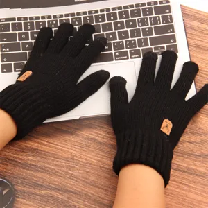 Detailed view of black knit touchscreen gloves, winter warm thermal wool-feel design.