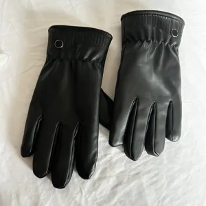 Detail view of winter black leather gloves, fleece lined and windproof design, close up.