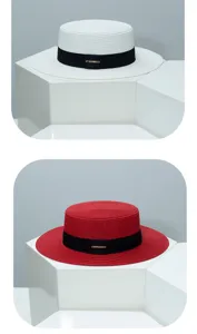Details of stylish flat top straw hat with black ribbon, perfect for summer sun protection.