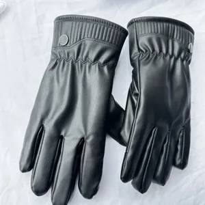 Detailed view of black winter leather gloves featuring plush warm lining and windproof cuffs.