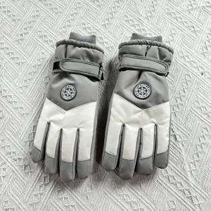 Detail view of winter ski gloves with waterproof fabric, plush lining, and adjustable wrist strap.