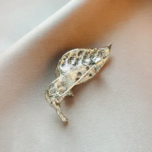 Detailed view of the silver-tone metal leaf brooch back pin, showing secure clasp design.
