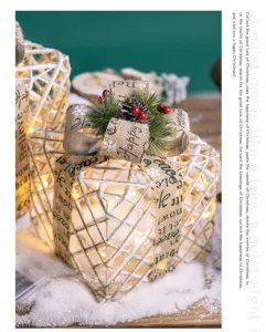 Macro detail of lighted Christmas gift boxes with burlap ribbons and red berries
