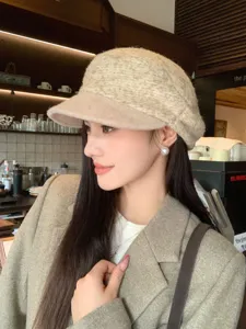 Detail view of stylish textured tweed newsboy cap, elegant beige beret for autumn and winter warmth.