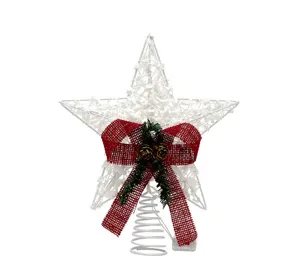 Detailed view of white ironwork Christmas tree topper star with red bow decoration