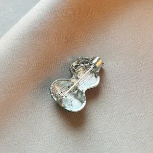 Silver tone metal gourd brooch back detail showing secure pin clasp craftsmanship accessory
