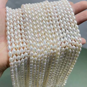 Macro detail of 5mm high-gloss natural freshwater oval pearls for DIY jewelry.