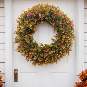 Vibrant autumn artificial boxwood wreath detail displayed on a classic white front door
