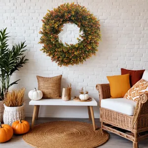 Artificial boxwood wreath in autumn colors hanging on a white brick wall in a cozy room