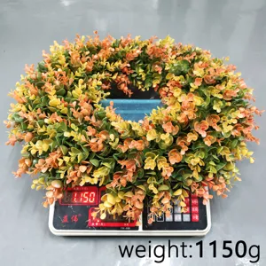 Detailed view of artificial eucalyptus wreath on scale showing 1150g product weight