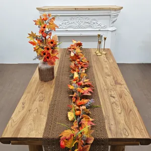 Autumn maple leaf garland with sunflowers and pumpkins displayed on a wooden table