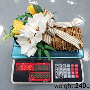 Close-up detail of artificial magnolia and tulip basket decoration weighing exactly 240g