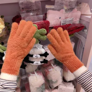 Winter fuzzy knitted fingered gloves in bright orange with warm soft plush fleece material.