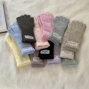 Knit fingerless gloves detail view, featuring cute lace tags and multiple warm color options.