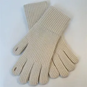 Close-up detail of women's warm knitted ribbed wool gloves with finger openings in beige.