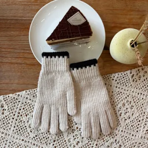 Cozy winter knit gloves with contrast black cuffs, warm woolen fabric for cold weather style.