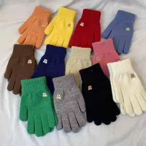 Colorful knitted winter gloves with cute bear embroidery detail, warm touchscreen design.