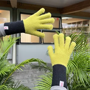 Detailed view of women's knitted long gloves, green and black color block split finger design.