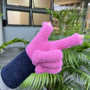 Close-up detail of knitted fingerless gloves in pink and dark blue, showing the plush texture.