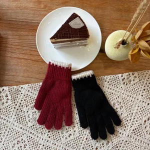 Detailed view of winter warm knit gloves in red and black, soft woolen texture for cold weather.