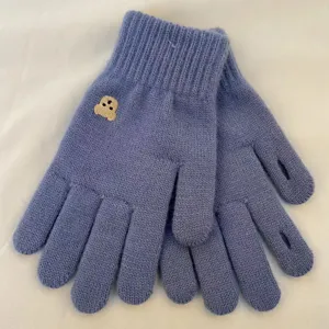 Cozy knitted winter gloves in solid blue with cute bear embroidery, warm and stylish.